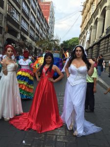 people in parade wear formal gowns